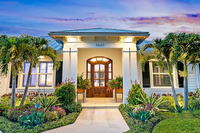 view of exterior entry at dusk