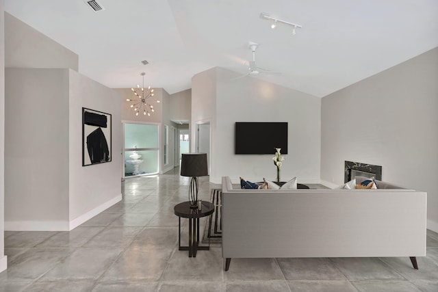 living room featuring ceiling fan with notable chandelier, lofted ceiling, and rail lighting