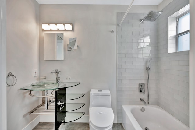 bathroom with toilet and tiled shower / bath