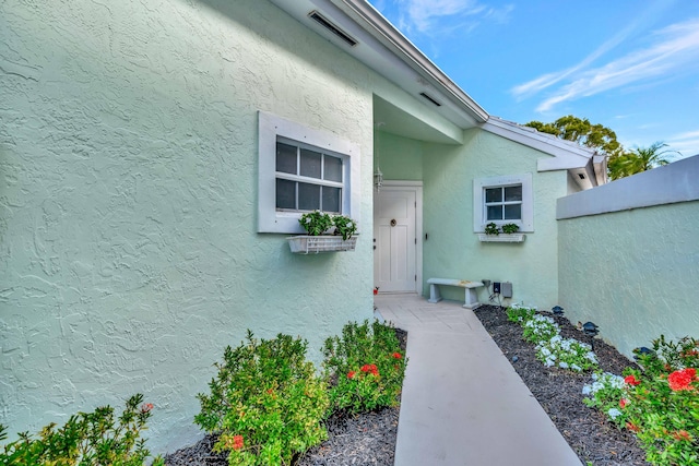 3 Dorchester Cir, Palm Beach Gardens, FL 33418 - property entrance featuring stucco siding and fence
