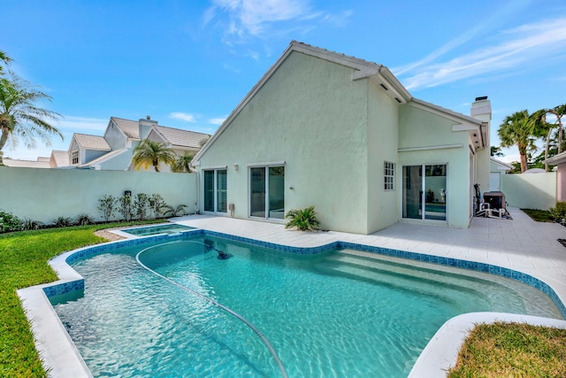 view of pool featuring an in ground hot tub and a patio