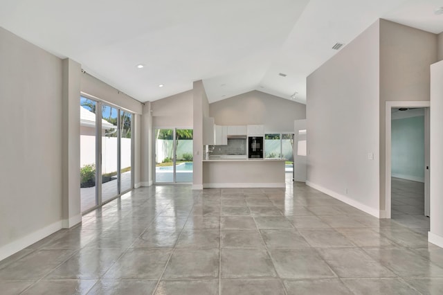 3 Dorchester Cir, Palm Beach Gardens, FL 33418 - unfurnished living room featuring concrete flooring, high vaulted ceiling, and baseboards