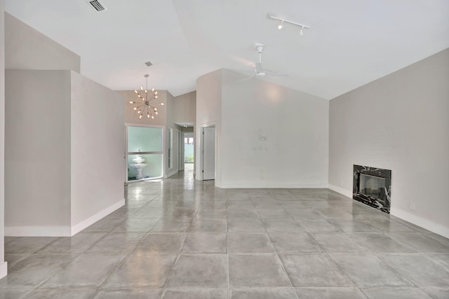 unfurnished living room featuring a high end fireplace, ceiling fan with notable chandelier, track lighting, and vaulted ceiling