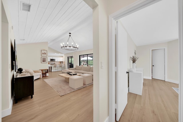 living room featuring light hardwood / wood-style flooring, wood ceiling, lofted ceiling, and an inviting chandelier