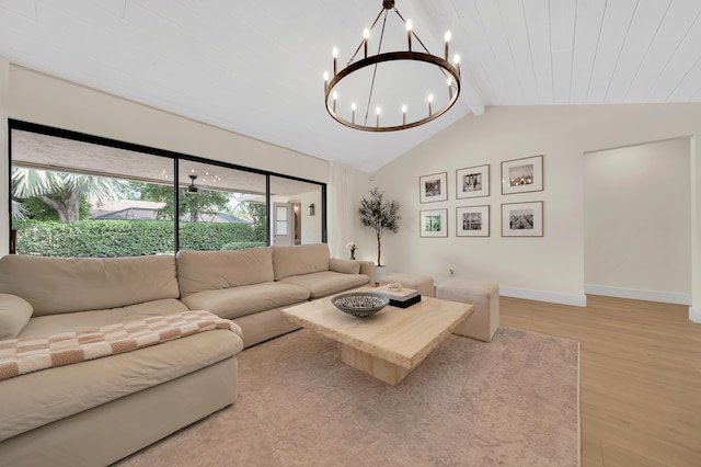 living room with light hardwood / wood-style flooring, vaulted ceiling with beams, and a chandelier