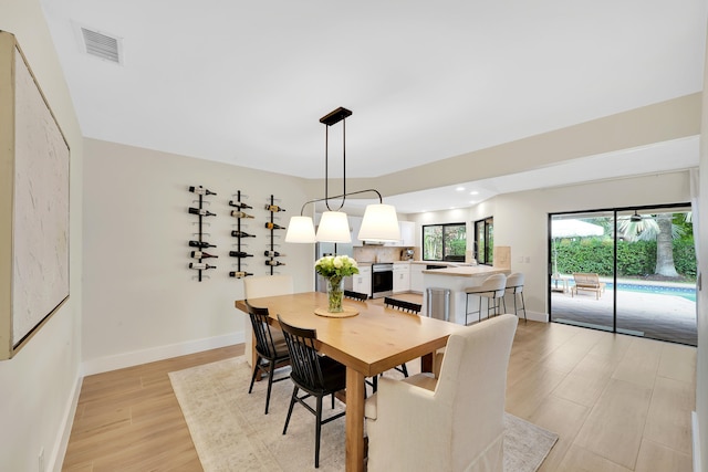 dining area featuring light wood-type flooring