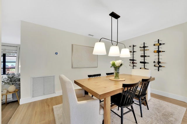 dining space featuring light wood-type flooring