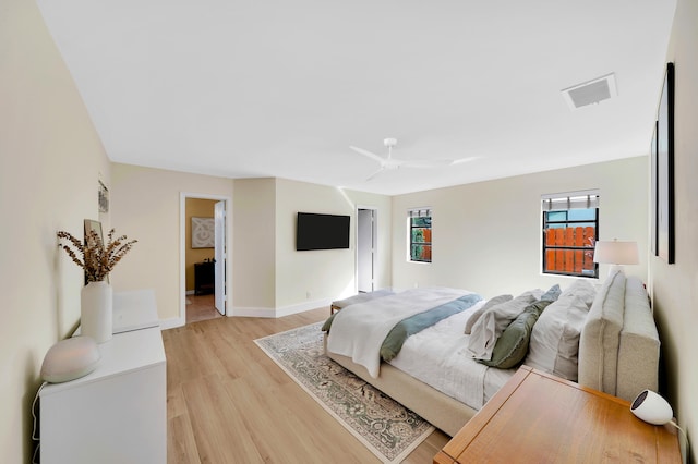 bedroom with ceiling fan and light hardwood / wood-style flooring