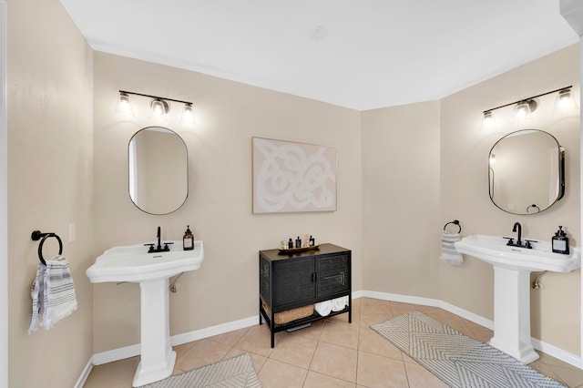 bathroom with dual sinks and tile patterned flooring