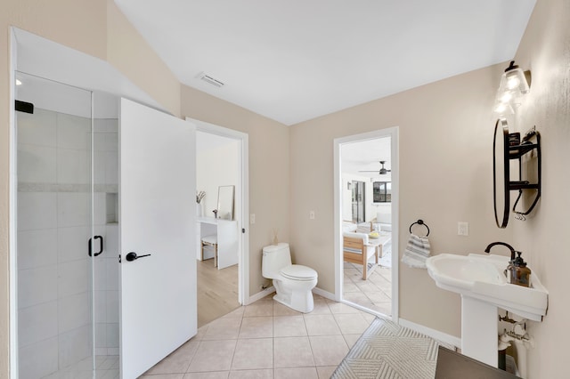 bathroom featuring sink, toilet, tile patterned flooring, an enclosed shower, and ceiling fan