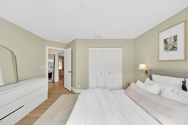 bedroom featuring a closet and light wood-type flooring