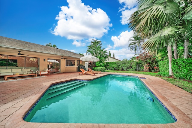 view of swimming pool featuring outdoor lounge area, a patio, and ceiling fan