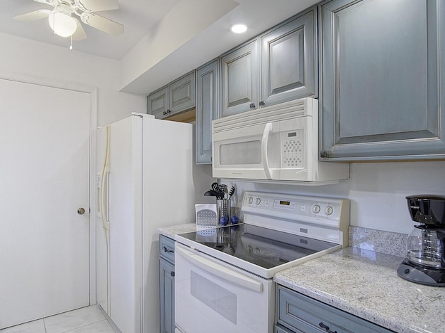2400 S Ocean Dr Unit 6112, Fort Pierce, FL 34949 - kitchen featuring white appliances, gray cabinetry, a ceiling fan, and light tile patterned floors