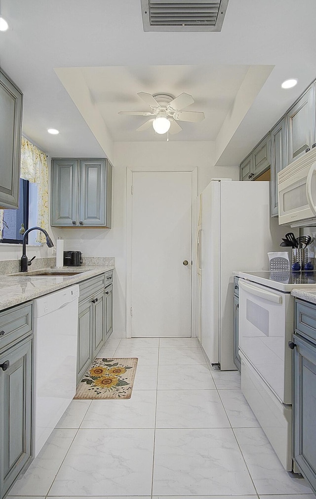 2400 S Ocean Dr Unit 6112, Fort Pierce, FL 34949 - kitchen with white appliances, gray cabinets, a sink, ceiling fan, and light countertops