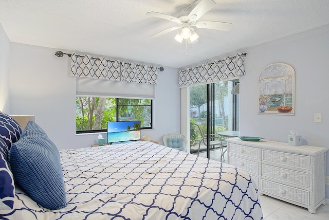 2400 S Ocean Dr Unit 6112, Fort Pierce, FL 34949 - bedroom featuring access to exterior, a ceiling fan, light tile patterned floors, and a textured ceiling