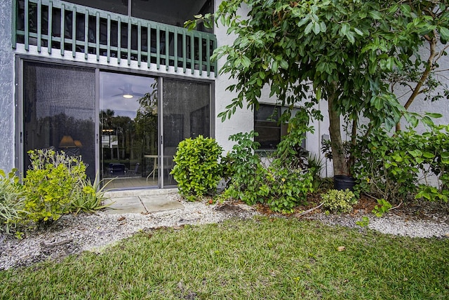 2400 S Ocean Dr Unit 6112, Fort Pierce, FL 34949 - doorway to property with a lawn and stucco siding