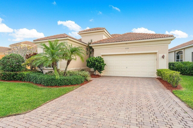 mediterranean / spanish house with a garage and a front yard