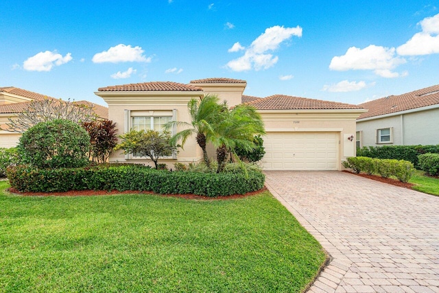 mediterranean / spanish-style house featuring a garage and a front yard