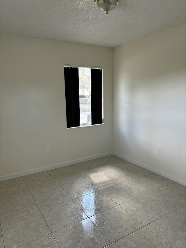 empty room with a textured ceiling