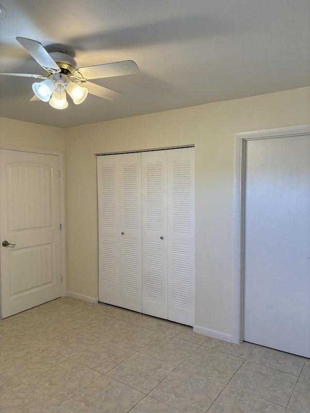 unfurnished bedroom featuring light tile patterned floors, ceiling fan, and a closet