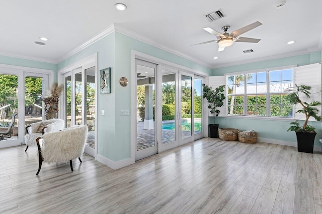 sunroom / solarium featuring ceiling fan and french doors