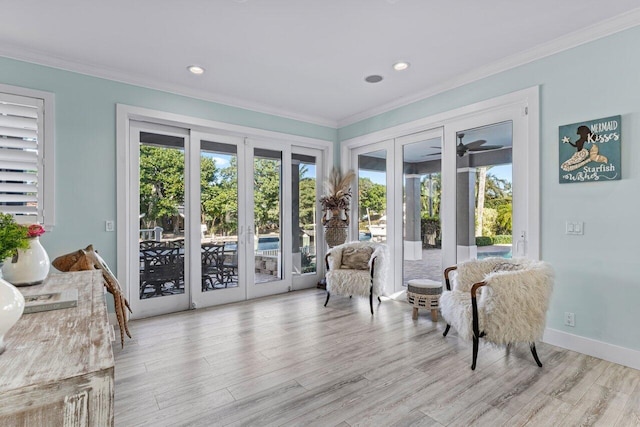 sitting room featuring crown molding, a wealth of natural light, and french doors