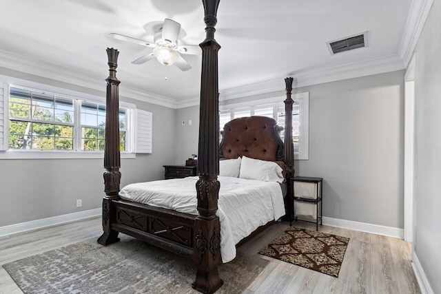 bedroom with ceiling fan, ornamental molding, and light hardwood / wood-style flooring