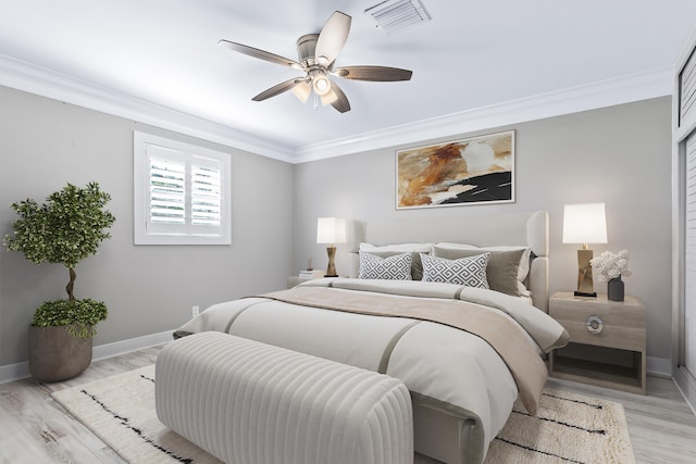 bedroom featuring ceiling fan, light hardwood / wood-style flooring, and ornamental molding