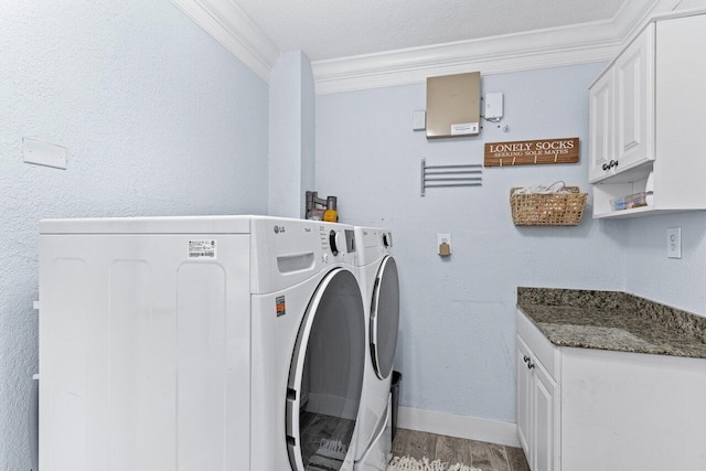 clothes washing area with cabinets, a textured ceiling, crown molding, light hardwood / wood-style flooring, and independent washer and dryer