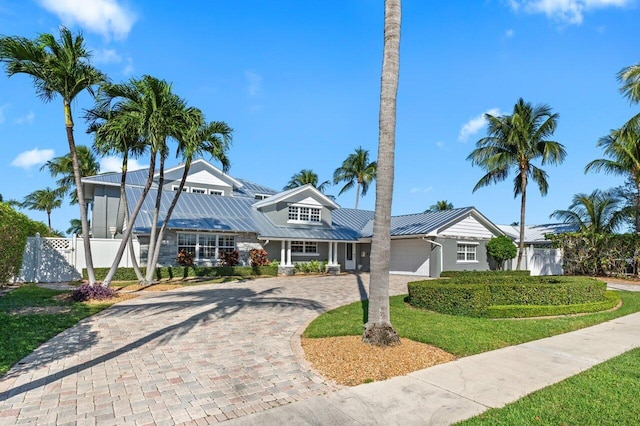 view of front of property featuring a garage and a front yard