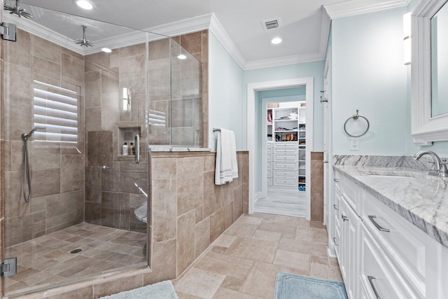 bathroom with crown molding, vanity, and an enclosed shower