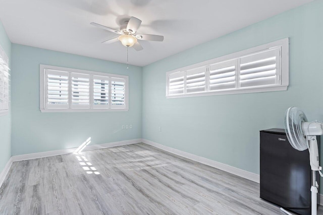 spare room with light hardwood / wood-style flooring and ceiling fan