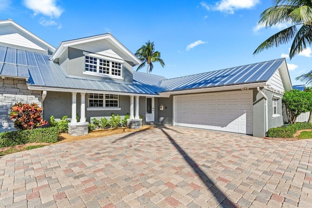 view of front of house featuring central AC and a garage