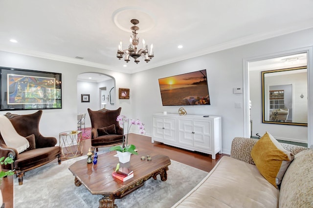 living room featuring ornamental molding, arched walkways, recessed lighting, and wood finished floors