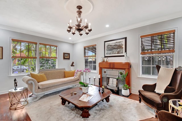 living room with crown molding, baseboards, and wood finished floors