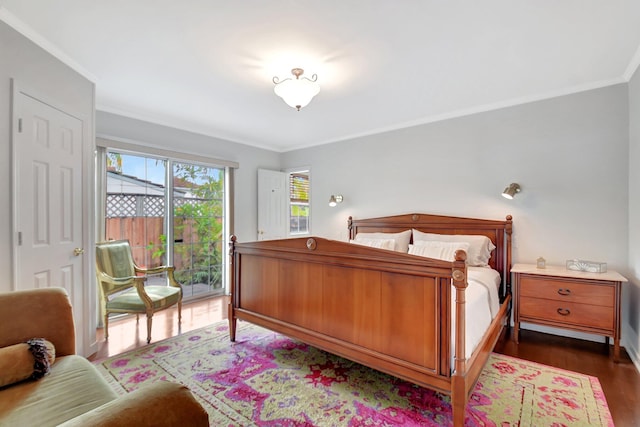 bedroom with access to exterior, ornamental molding, and wood finished floors