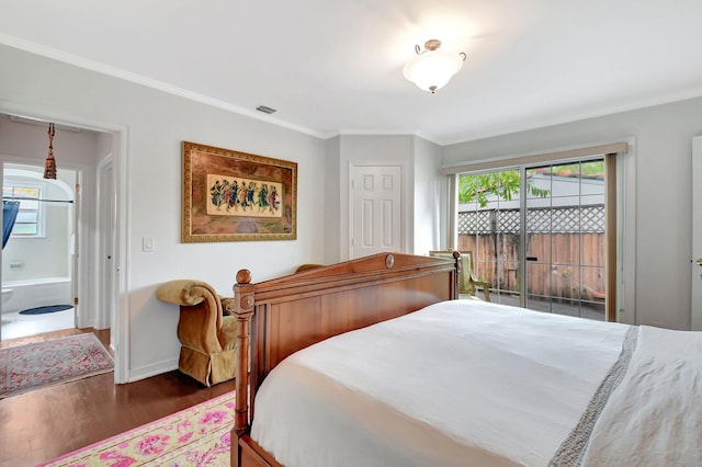 bedroom featuring wood finished floors, visible vents, and crown molding