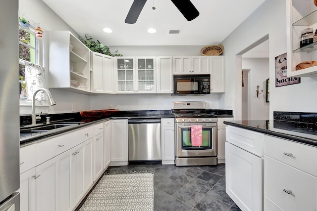 kitchen with appliances with stainless steel finishes, white cabinetry, a sink, and open shelves