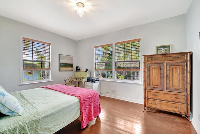 bedroom with baseboards and hardwood / wood-style floors