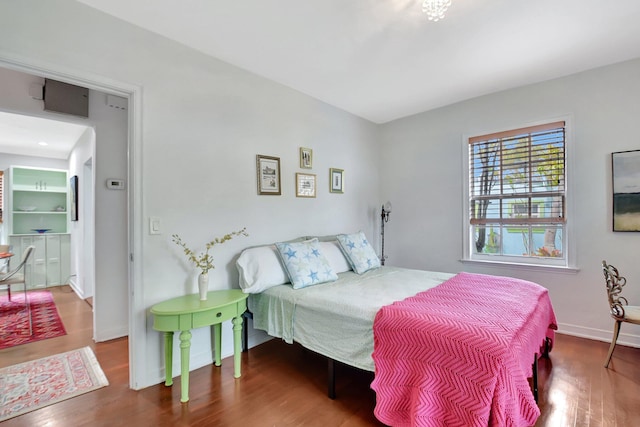 bedroom featuring wood finished floors and baseboards