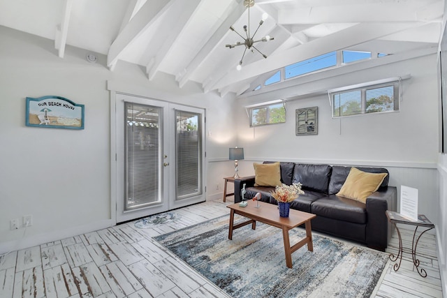 living room featuring lofted ceiling with beams, french doors, wood finished floors, and an inviting chandelier