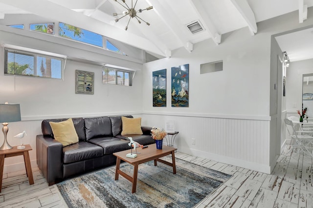 living area with vaulted ceiling with beams, an inviting chandelier, visible vents, and wainscoting