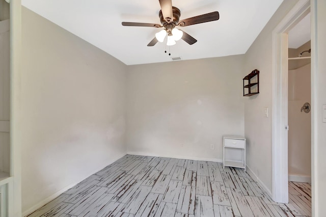 spare room with light wood-style flooring, visible vents, and ceiling fan