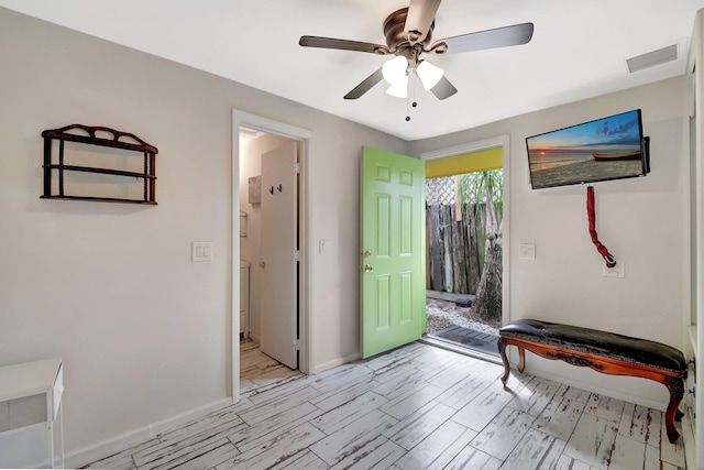 interior space with light wood-style floors, visible vents, baseboards, and a ceiling fan