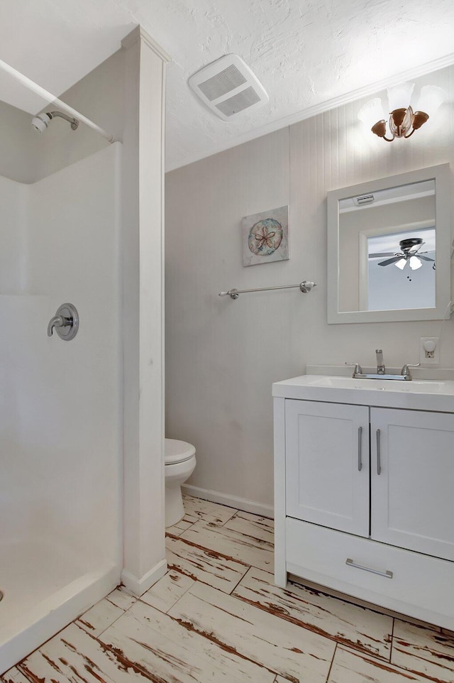 bathroom featuring visible vents, toilet, a shower stall, and vanity