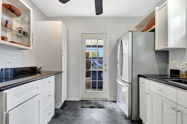 kitchen featuring open shelves, dark countertops, and white cabinetry