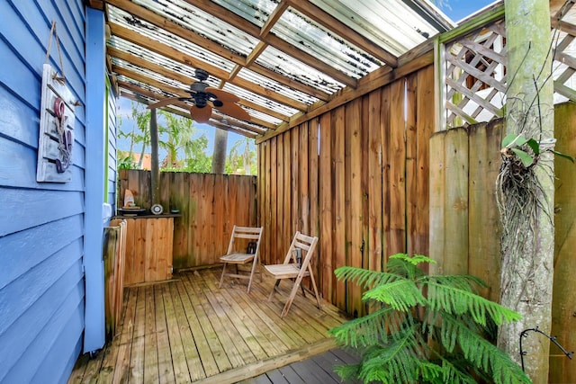 wooden deck featuring ceiling fan