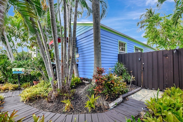 view of property exterior with a gate and fence