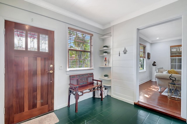 foyer featuring baseboards and crown molding