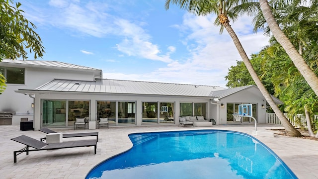 view of swimming pool featuring an outdoor living space and a patio